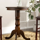 RAM Game Room Pub Table - Cappuccino with glass top and a small vase of greenery displayed.