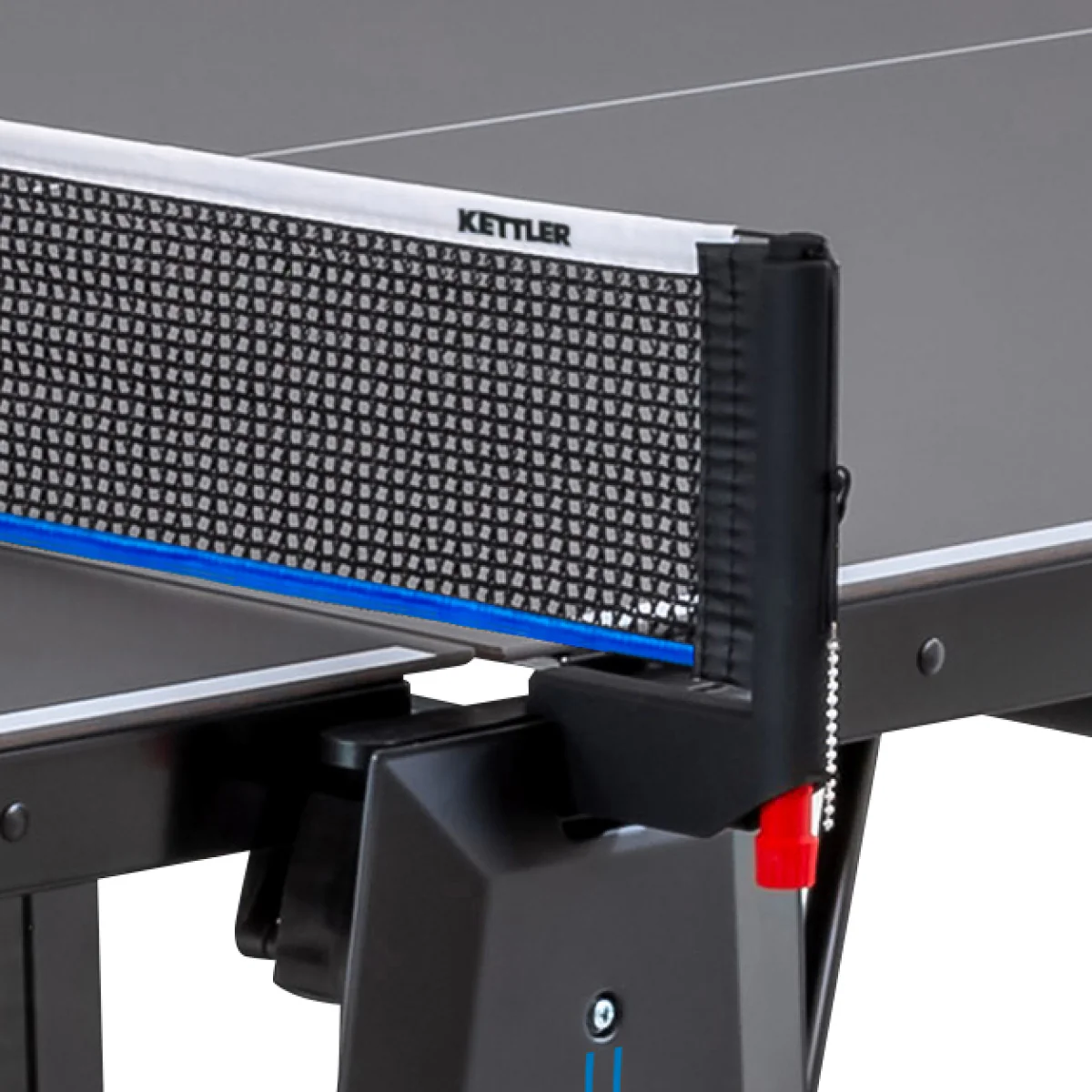Close-up of a Kettler Sedona Outdoor Table Tennis Table net on a black surface.