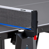 Close-up of a Kettler Sedona Outdoor Table Tennis Table net on a black surface.