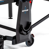 Close-up of Kettler Sedona Outdoor Table Tennis Table leg with wheels and paddle holder.