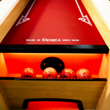 Close-up of a red bowling alley with wooden sides and 'Made in America since 1906' text.