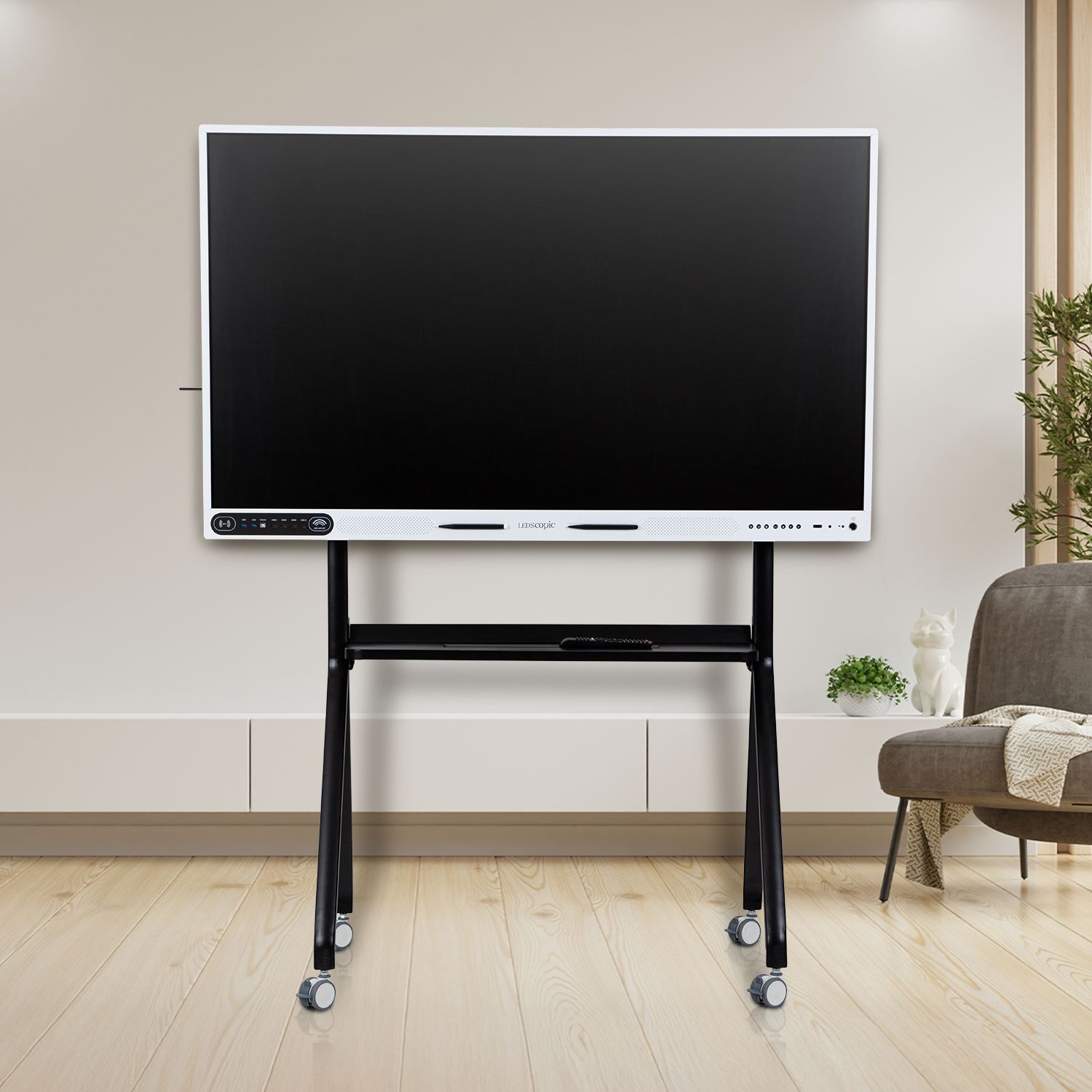 Large Smart Board on a stand in a room with a chair and plant
