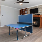 A Butterfly Active 16 Table Tennis Table set up in a bright indoor space, showcasing its sleek blue playing surface, sturdy frame, and adjustable legs. 