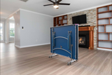 A Butterfly Active 16 Table Tennis Table set up in a bright indoor space, showcasing its sleek blue playing surface, sturdy frame, and adjustable legs. 