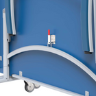 White metal frame with curved bar and wheels against a blue background