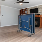 Blue folding table on wheels in a living room setting
