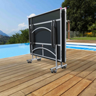 Portable sunshade on a wooden deck by a pool with scenic background