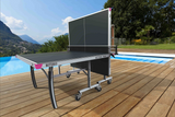 Butterfly outdoor ping pong table on a wooden deck with a scenic background