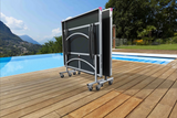 Foldable outdoor table on wheels by a pool with scenic background