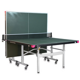 A vibrant green Butterfly Easifold DX 22 table tennis table, showcasing its sleek design and sturdy construction, set up for play in a well-lit indoor space.