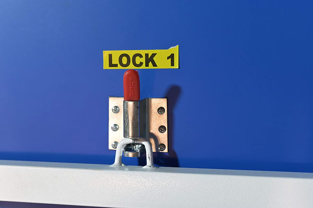 Red push lock labeled Lock 1 on a Butterfly National League 25 blue table tennis table.