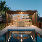 RAM Game Room 60" Bamboo Tiki Bar with stools sits under a pergola by the pool at dusk.