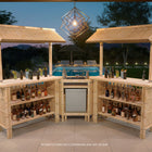 RAM Game Room 60" Bamboo Tiki Bar with stools, bottles, and poolside lounge at dusk.