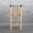 A wooden ladder gym stands by RAM Game Room bamboo tiki bar stools on a gray concrete floor.