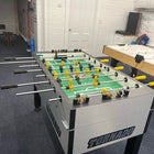 A Tornado Tournament Competition T-3000 Foosball Table sits in a game room with white walls.