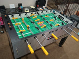 Tornado T-3000 Foosball Table in silver with yellow and black handles on green field.