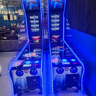Two Valley Jet-Pong machines by Valley glow blue in a game room.