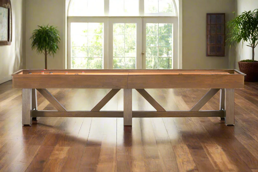 A Brunswick Billiards Botanic 12' Shuffleboard Table sits in a bright room with wood floors.