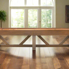 A Brunswick Billiards Botanic 12' Shuffleboard Table sits in a bright room with wood floors.