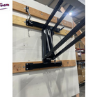 Wooden shelf with metal brackets against a white wall in a warehouse setting.