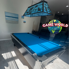 Modern pool table with blue felt in a room with a 'Game World Planet' sign.