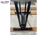 Black metal stand on a wooden platform with 'First Team' branding.