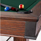 Close-up of Brunswick Billiards Canton 7' Pool Table in Black Forest with balls and cue near pocket.