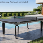 A Kettler outdoor pool table with a black playing surface and dark metal legs, positioned next to a swimming pool on a stone patio. The image includes a text overlay at the top stating '*Conversion tops only - Pool table is not included' to clarify that the listing is for the conversion tops only.
