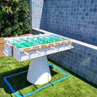 Kettler FAS Ciclope White Outdoor Foosball Table near steps, tiled wall & Game World Planet logo.
