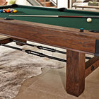 The Brunswick Billiards Canton 7' Pool Table in Black Forest on a tiled floor with balls and cues.
