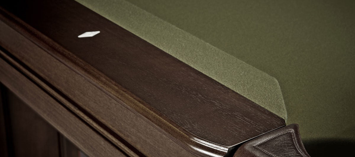 Close-up of Brunswick Billiards OAKLAND II 8' Pool Table corner with dark wood trim and diamond marker.