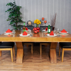 A BBO The Helmsley Poker Table with Dining Top, set for four with red napkins, plates, glasses.