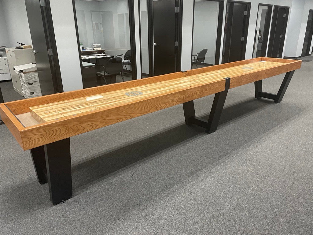 The Champion 16' Fremont Shuffleboard Table adds style to this office with its sleek black trim.