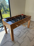 Venture Wooden foosball table in a room with a window and carpeted floor.
