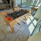 Venture Buckhead Foosball Table in a modern living room with large windows.