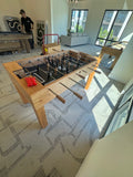 Venture Buckhead Foosball Table in a modern living room with large windows.