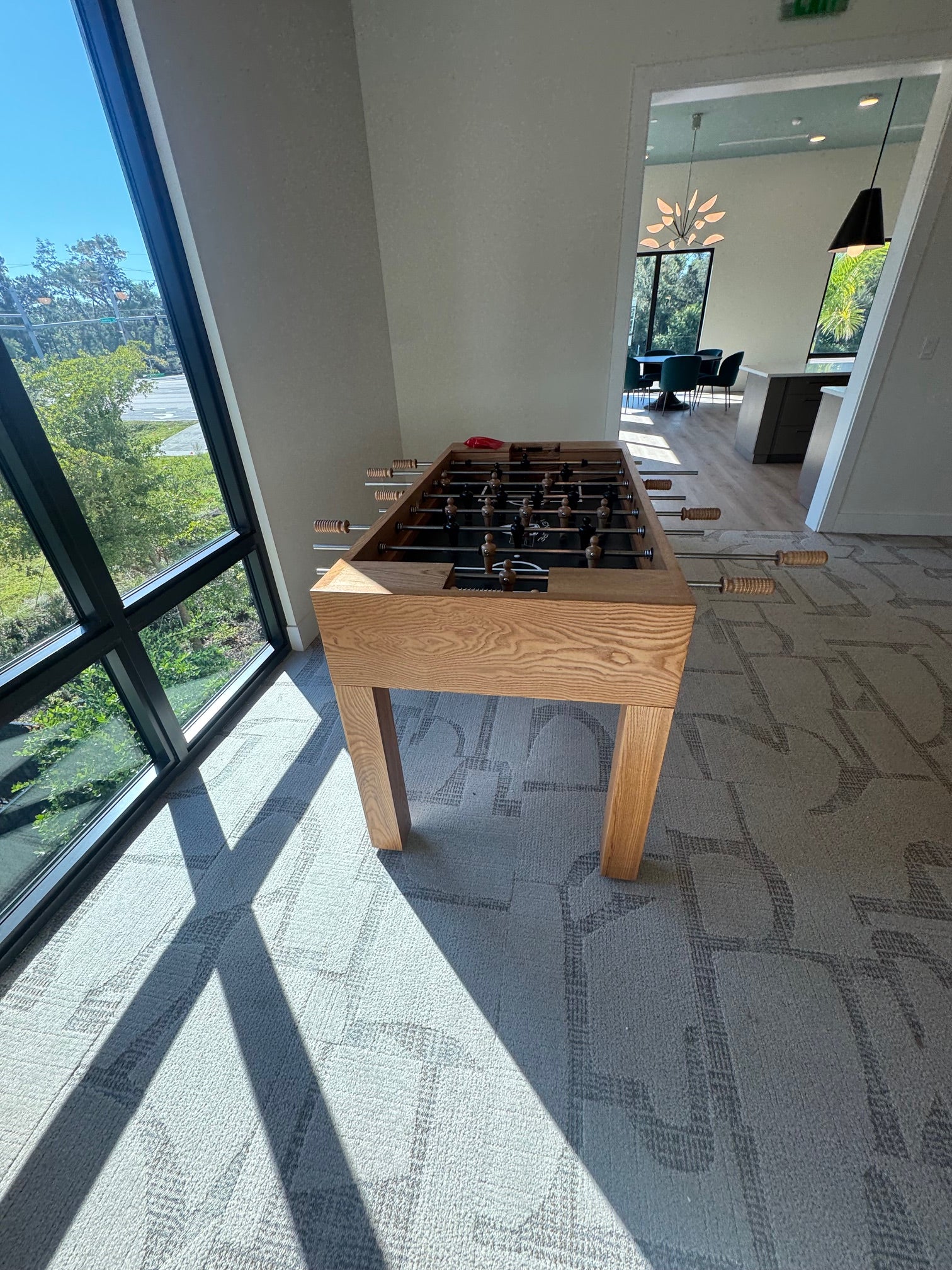 Venture Buckhead Foosball Table on a carpet in a room with window.