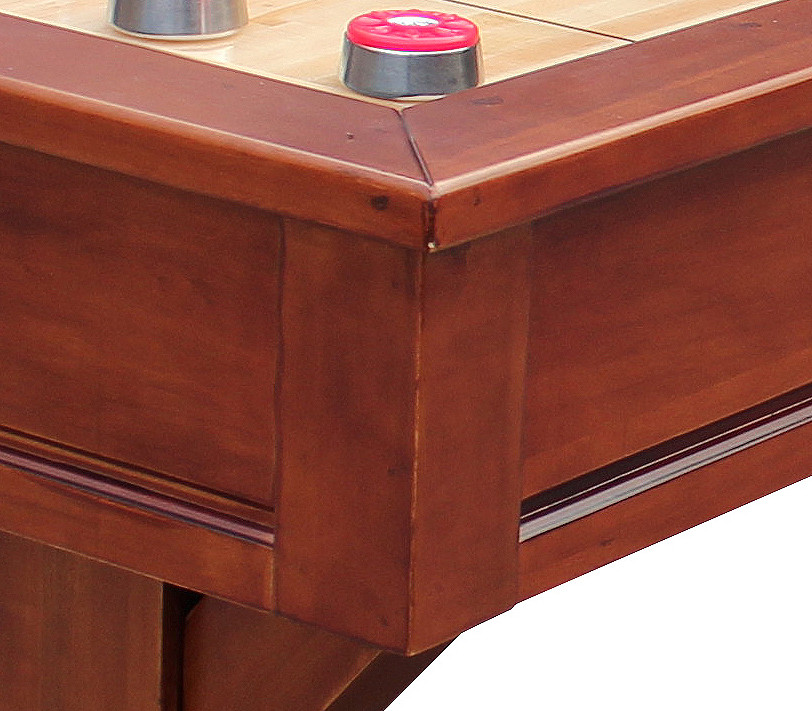 Close-up of a wooden pool table with a red and silver pool cue holder.