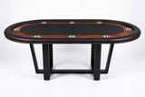 An oval poker table with a dark wood grain top, black felt playing surface, black padded edges, and black metal legs, shown on a white studio background.