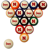 A set of 16 billiard balls arranged in a triangle on a white background, with one ball separated at the bottom left. The balls feature the Nebraska Huskers logo in red on cream, orange, blue, purple, green, black, and red panels.