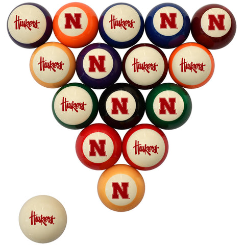 A set of 16 billiard balls arranged in a triangle on a white background, with one ball separated at the bottom left. The balls feature the Nebraska Huskers logo in red on cream, orange, blue, purple, green, black, and red panels.