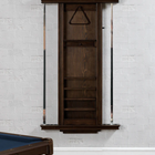 Wooden wall-mounted pool cue rack against a white brick wall.