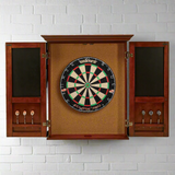 Dartboard with wooden cabinet on a white brick wall background