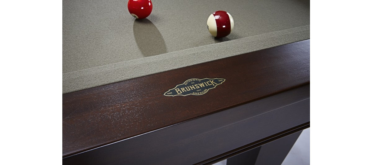 Close-up of a Brunswick Billiards Winfield 8' Pool Table with two balls on green felt.