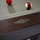 Close-up of a Brunswick Billiards Winfield 8' Pool Table with two balls on green felt.