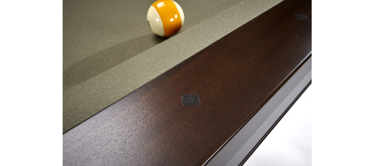 Close-up of Brunswick Billiards Winfield 8' Pool Table edge with yellow and white ball by rail.
