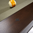 Close-up of Brunswick Billiards Winfield 8' Pool Table edge with yellow and white ball by rail.