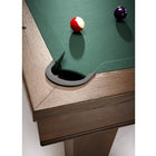 Corner pocket of a Brunswick Billiards Winfield 8' Pool Table with red-striped and purple balls.