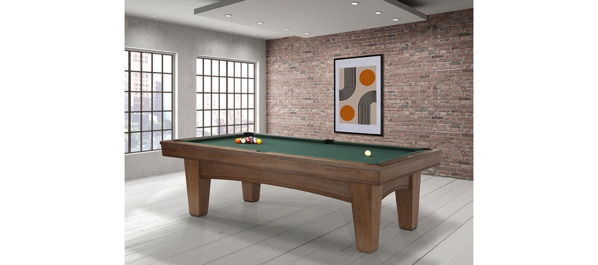 A Brunswick Billiards Winfield 8' Pool Table with balls in a modern brick-walled room.