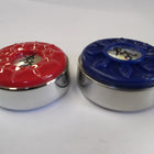 Two Playcraft shuffleboard weights, red and blue tops, on a white surface.